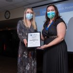 Heather Kelly receiving award certificate from CMHP President