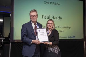 Paul Hardy receiving his certificate from Roz Gittins at the CMHP conference